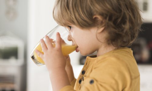 portrait-boy-drinking-glass-orange-juice_23-2148441958